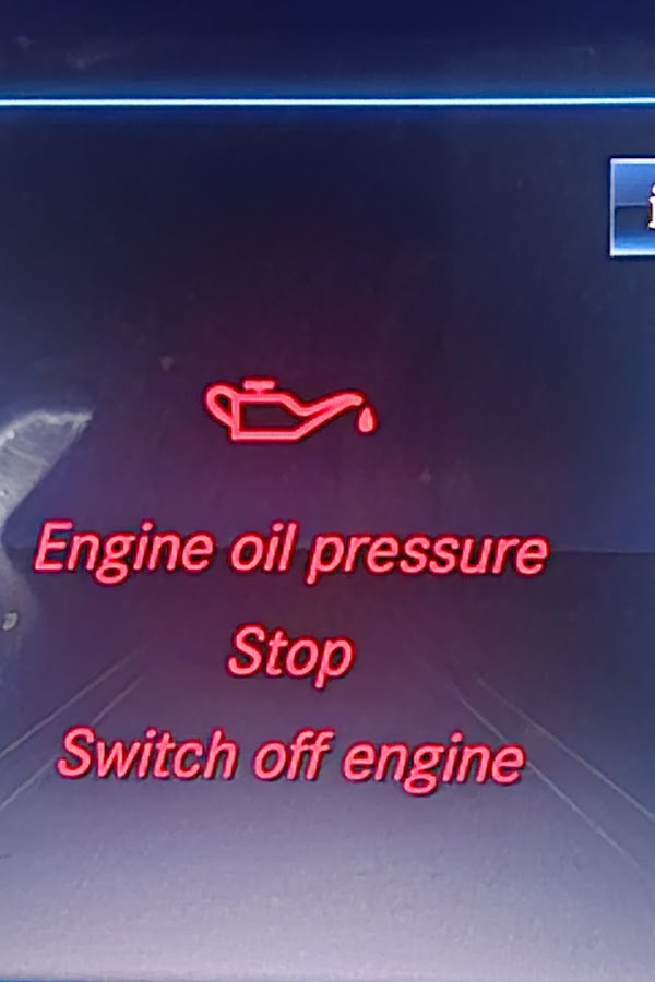 Car dashboard warning light displaying "Engine oil pressure — Stop — Switch off engine", indicating a critical engine fault requiring immediate roadside recovery