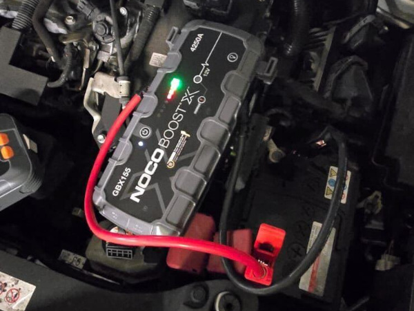 Prompt Recovery with a NOCO Boost X battery pack and jumper cables, jump-starting a car with a flat battery